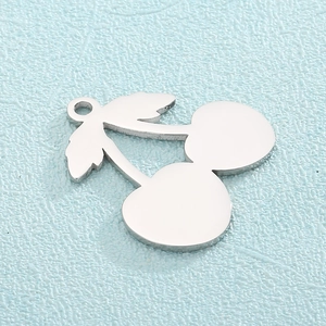 Macro shot of silver cherry metal pendant with smooth mirror finish and top hanging ring