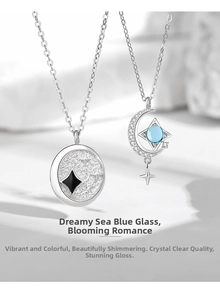 Detail of 925 sterling silver moon and star pendants with blue gemstone and relief