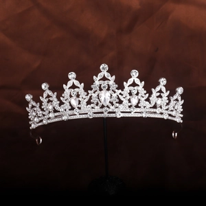 Close-up of elegant silver tiara with white rhinestones and pear-shaped crystals