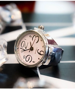 Vintage silver alloy ring watch with white numeric dial and quartz movement on ice props
