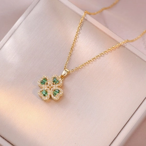 Golden clover necklace with green malachite and zircons in a jewelry gift box