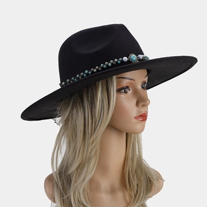 Detail of black wide brim fedora with turquoise beadwork and western style fringe