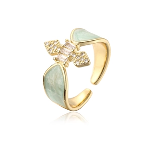 Macro detail of gold plated ring featuring green enamel and micro-pave cubic zirconia