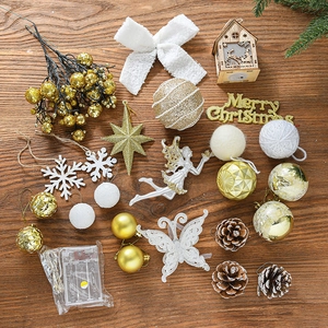 Golden Christmas tree ornament set with LED lights and glitter pendants on wood background