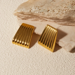 Detail of 18k gold plated trapezoid earrings with vertical striped texture on stone