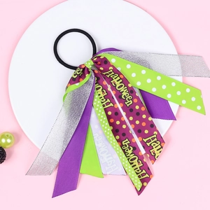 Macro shot of Halloween ribbon hair scrunchie with purple and green polka dot patterns