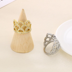 Detailed view of hollow crown rings in gold and silver with sparkling white rhinestones