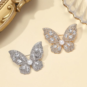 Elegant butterfly brooches in gold and silver with inlaid crystals and pearls