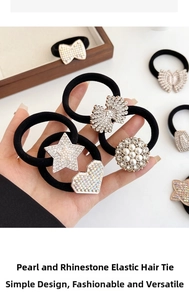 Macro detail of elastic hair ties with pearls, rhinestones, hearts and bowknot charms