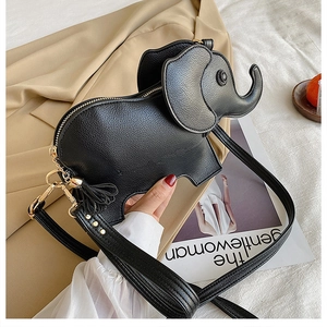 Detail of black elephant crossbody bag with lychee texture PU leather and tassel