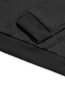 Close-up of black men's shirt showing jacquard texture and ribbed cuffs detail