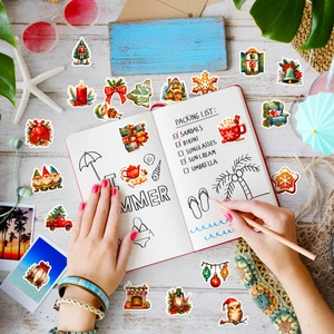 Detailed view of Christmas and beach stickers on a journal for festive DIY decoration