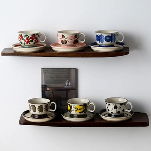 Hand-painted vintage ceramic coffee cup and saucer set with floral and fruit patterns