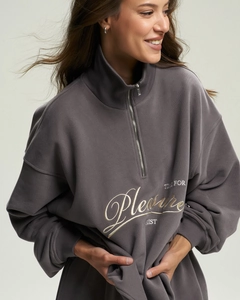 Close-up of gray half-zip sweatshirt featuring Pleasure embroidery and textured fleece fabric
