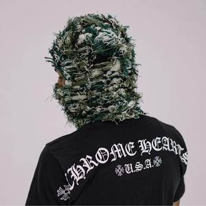 Distressed camo knit balaclava mask with fringe details and textured camouflage pattern