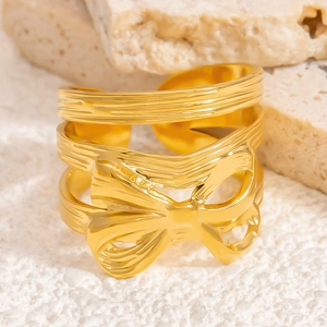 Gold stainless steel bow ring with irregular hollow lines and adjustable open band