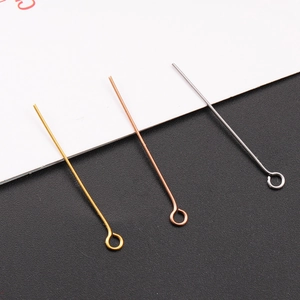 Macro detail of gold, rose gold and silver stainless steel eye pins for DIY jewelry making