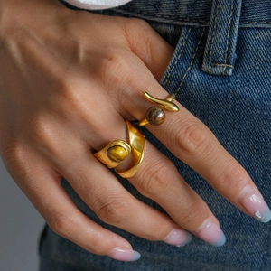 Vintage golden double-layer open ring set with irregular tiger eye stone on denim background