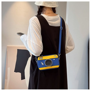 Fashionable camera-shaped crossbody bag featuring vibrant blue and yellow contrast leather detail