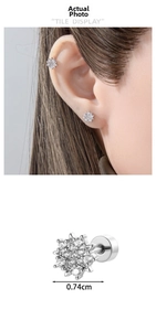 Macro detail of silver snowflake ear stud with white zircon and 0.74cm width marking
