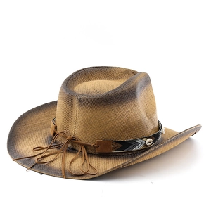 Detailed close-up of woven cowboy straw hat with gradient brim and ethnic patterned band