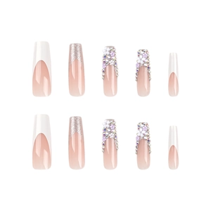 French white tip press-on nails with 3D floral accents and colorful rhinestones
