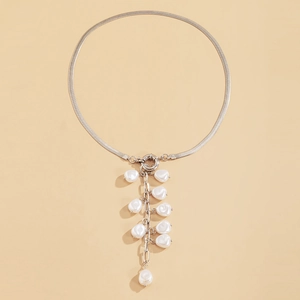 Close-up of silver flat snake chain with baroque imitation pearl tassel details