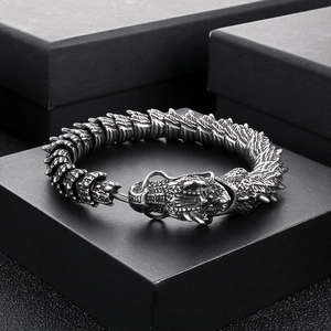 Retro dragon steel bracelet for men with green eyes on a matte black jewelry box
