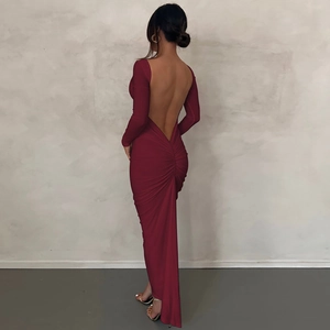 Detail view of burgundy backless maxi dress with long sleeves and pleated hip design