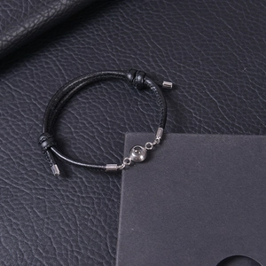 Detail of adjustable black woven leather cord bracelet with silver projection stone bead