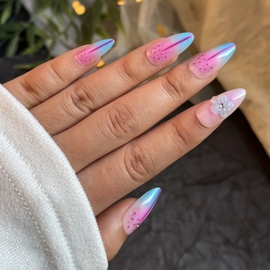 Short almond press-on nails with pink blue gradient and 3D floral accent decorations