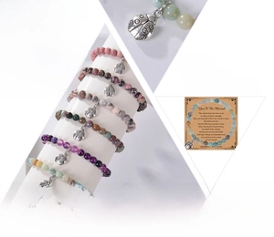 Detail of natural gemstone beaded bracelets featuring ladybug charms and display cards