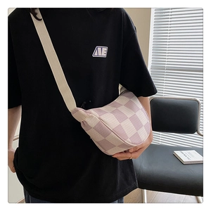 Close-up of lilac checkerboard knit crossbody bag with wide shoulder strap on model