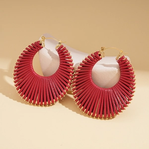 Detailed view of red woven bohemian earrings with unique fan-shaped geometric design