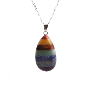 Macro detail of teardrop chakra pendant featuring seven layers of natural healing stones