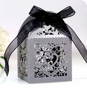Silver glitter heart-shaped candy box with hollow patterns and a black organza ribbon bow