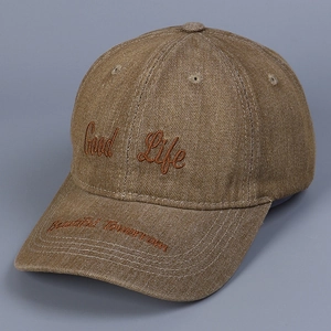 Detail of Good Life embroidery on brown washed denim baseball cap with vintage finish