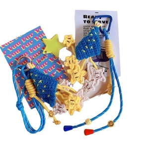 Handmade crocheted star keychain and bag pendant with blue cord and smiling face beads