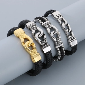 Detail of four punk braided leather bracelets with textured stainless steel clasps