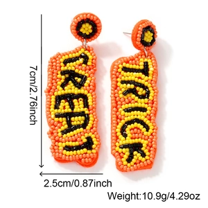 Handmade beaded Halloween earrings featuring orange and yellow patterns on white background