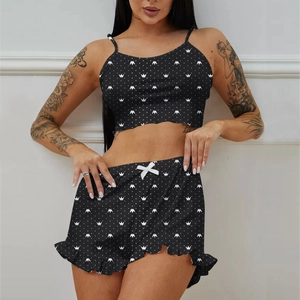 Detail of black camisole pajama set featuring white crown prints and ruffled hem shorts