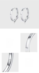 Detailed macro view of S925 sterling silver hoop earrings with a mirror-polished finish