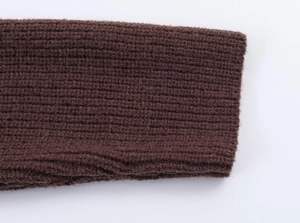 Macro view of dark coffee ribbed knit fabric showing the detailed texture and thickness