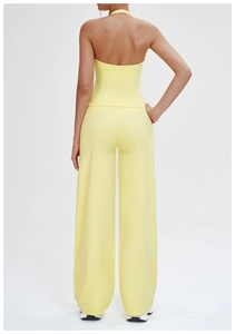 Back view of light yellow backless yoga set featuring halter top and wide leg pants