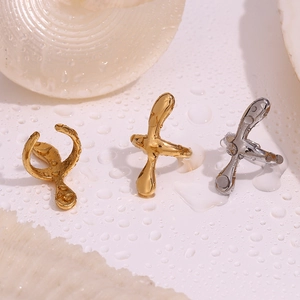 Macro shot of lava style gold and silver rings on water drops and shell background