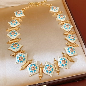 Detail of vintage heart necklace in gold finish with enamel inlay and lobster clasp