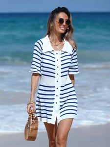Close-up of sailor-style blue and white striped knit dress with contrast lapel and buttons