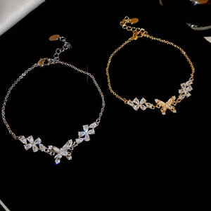 Macro shot of 18k gold and silver plated butterfly bracelets with sparkling zircons