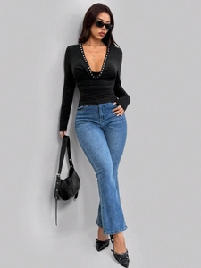 Women's sexy slim fit black long sleeve cowl neck top with blue flared denim jeans