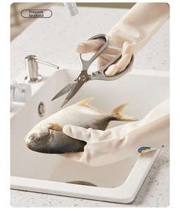 Close-up of anti-slip kitchen rubber gloves cleaning seafood in a kitchen sink